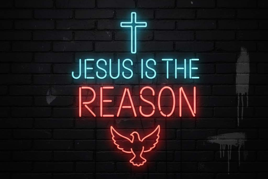 Neon sign with 'Jesus is the Reason' on a brick wall background