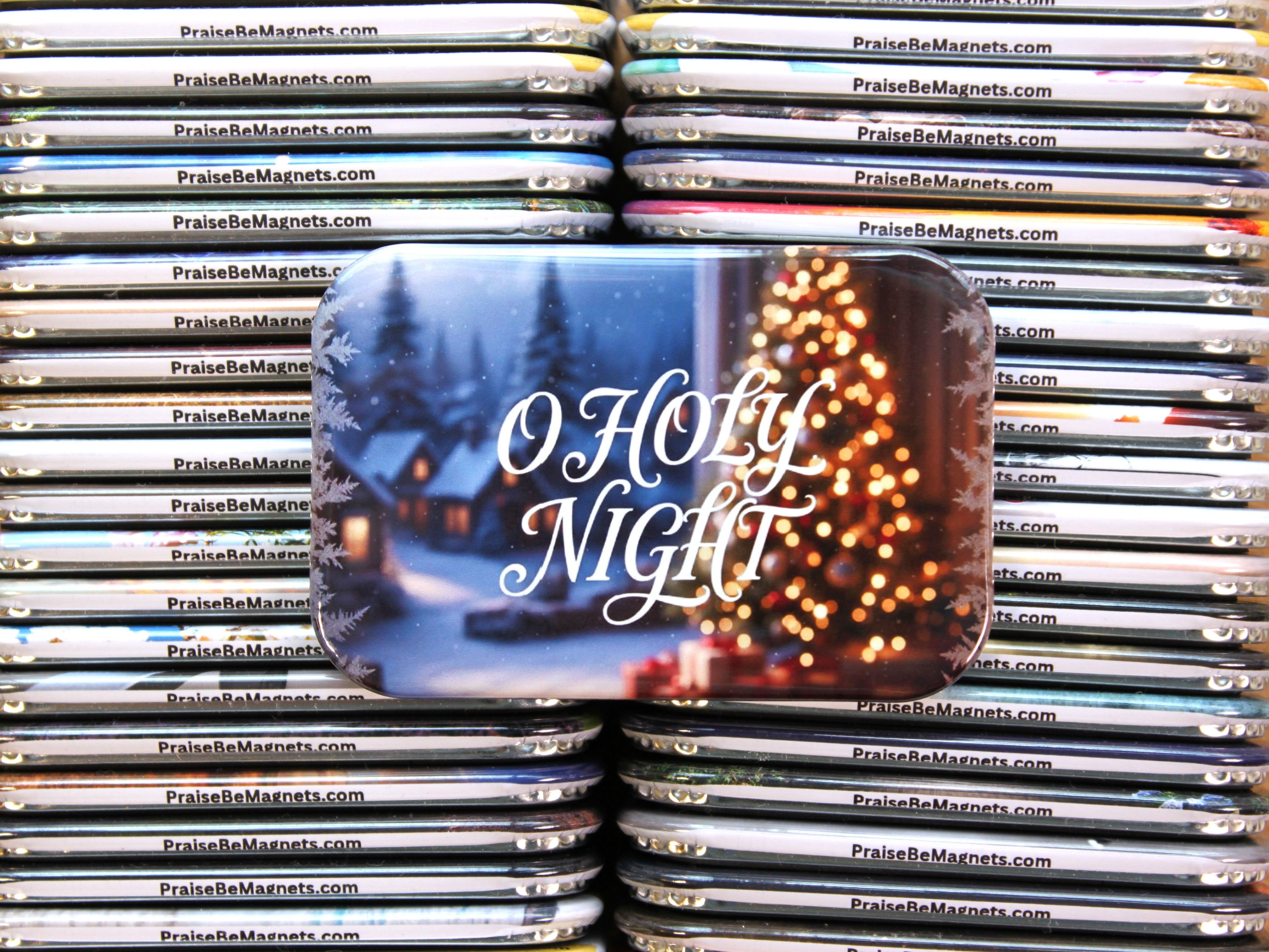 Stack of 'O Holy Night' Christmas magnet packaging with a festive design.