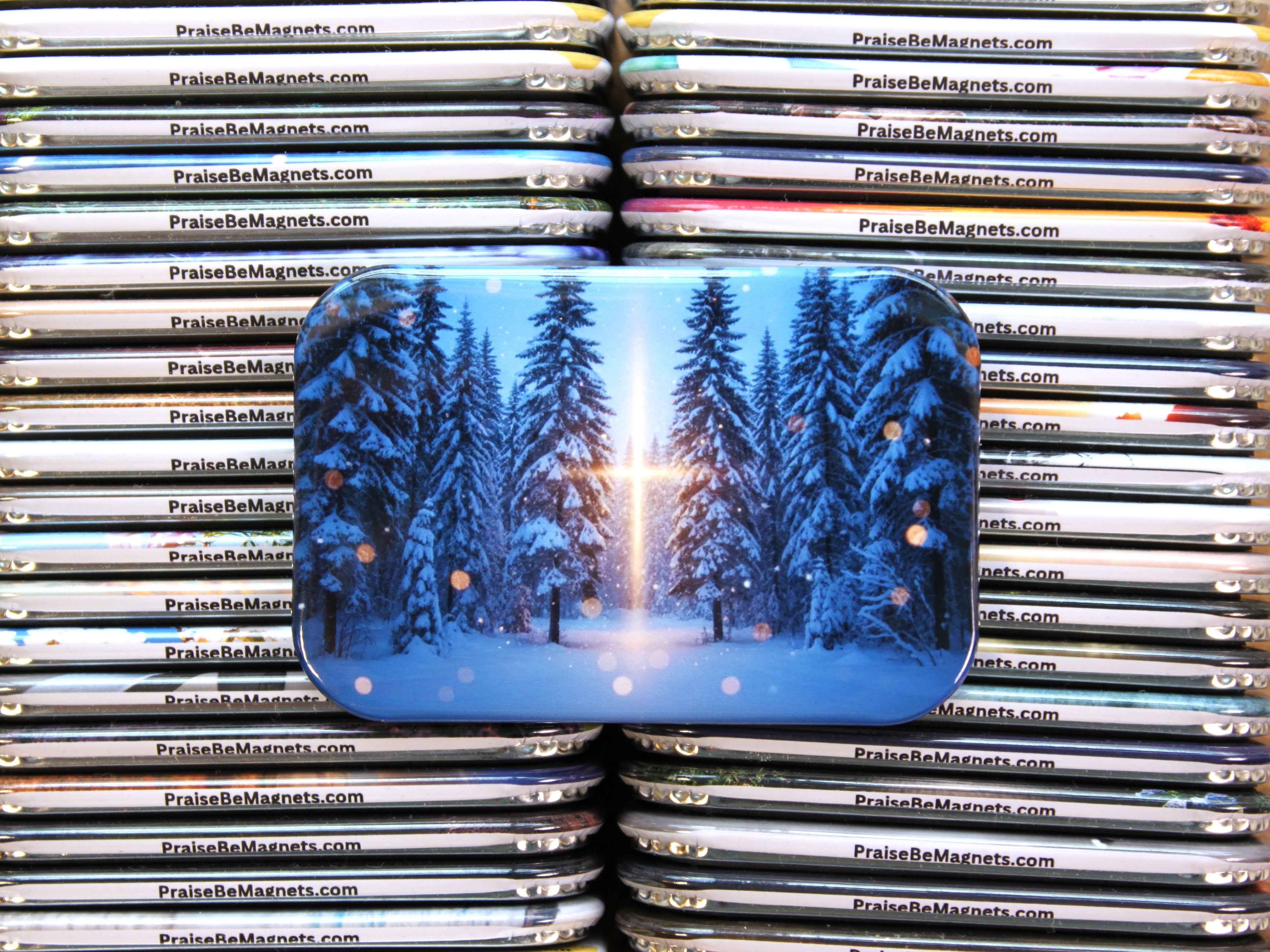 Stack of magnets with a blue design featuring trees and a sun, branded 'PraiseBeMagnets.com'.