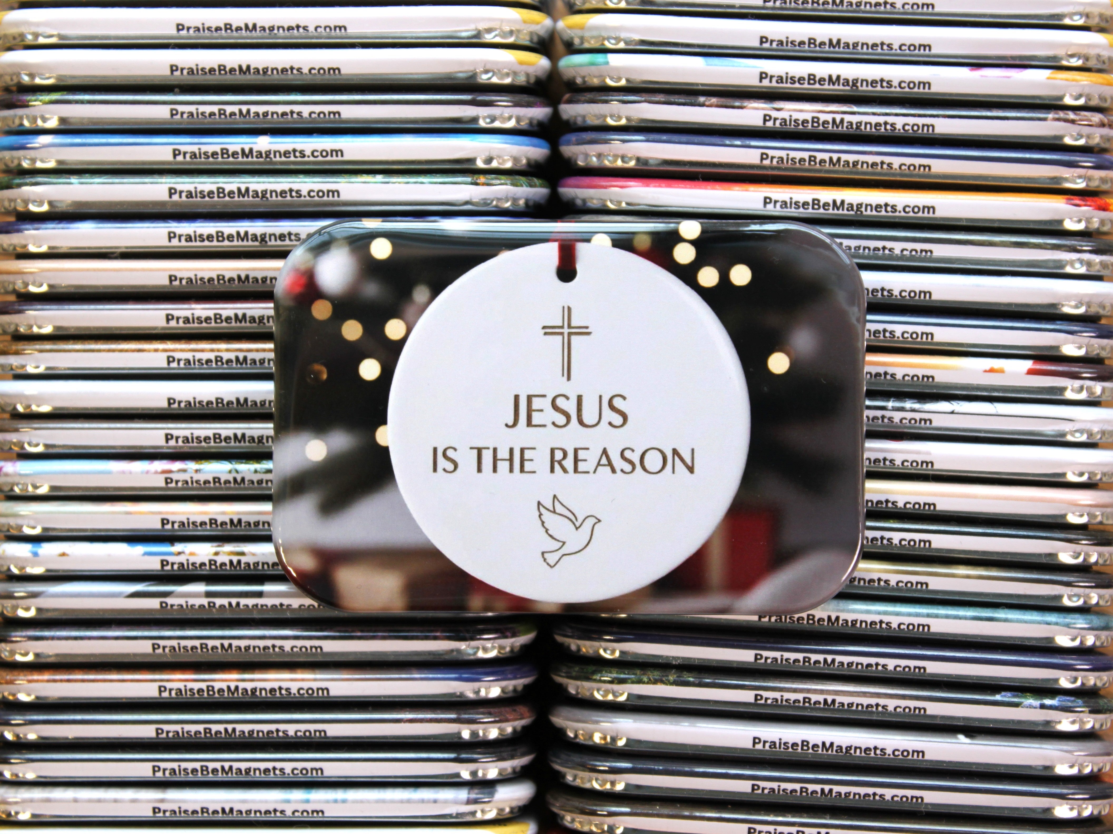 Stack of 'PraiseBeMagnets' with a circular magnet featuring 'Jesus is the Reason' text.