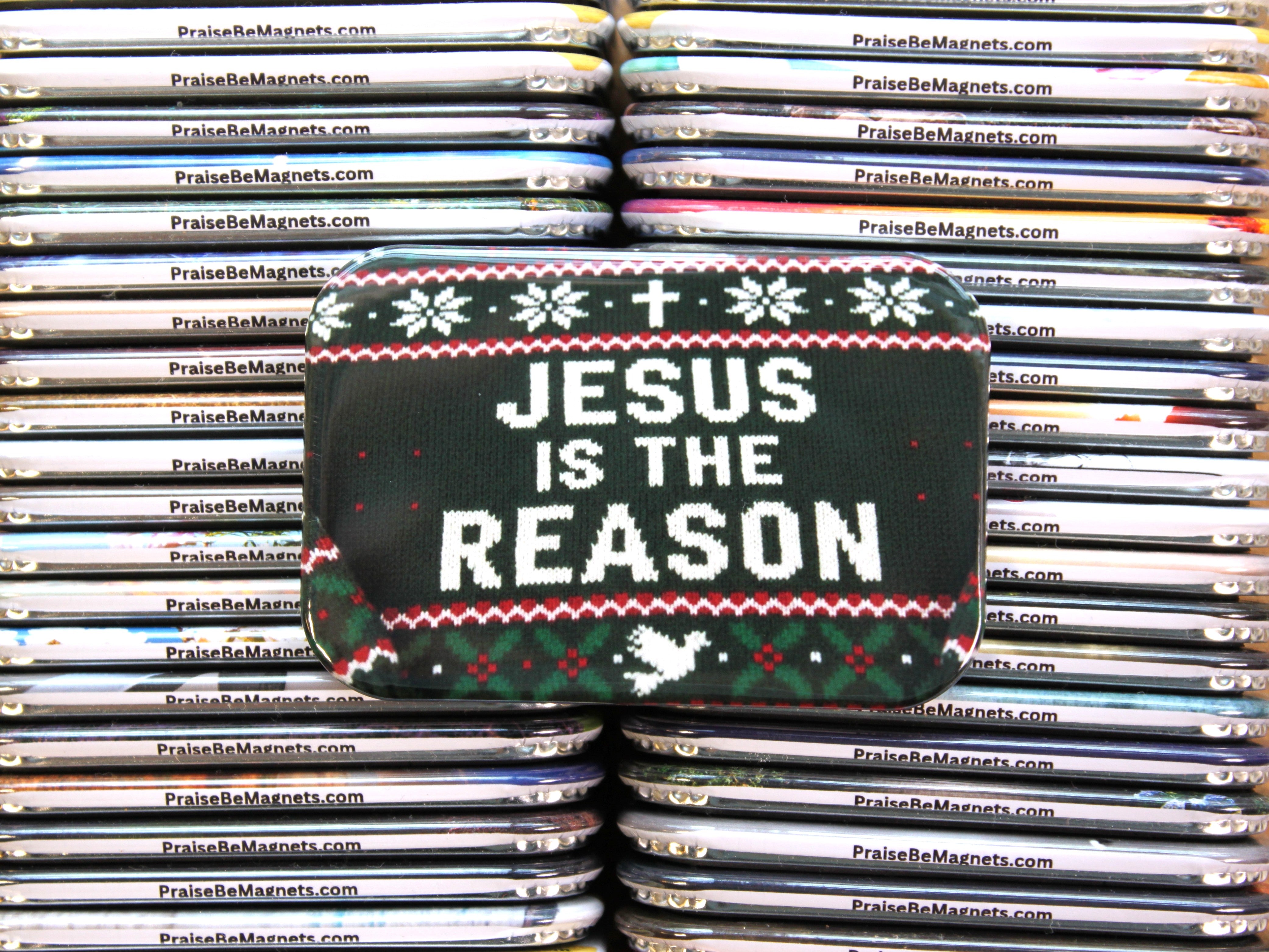 Stack of 'Praise Be Magnets' with a Christmas-themed pouch displaying 'Jesus is the Reason'.