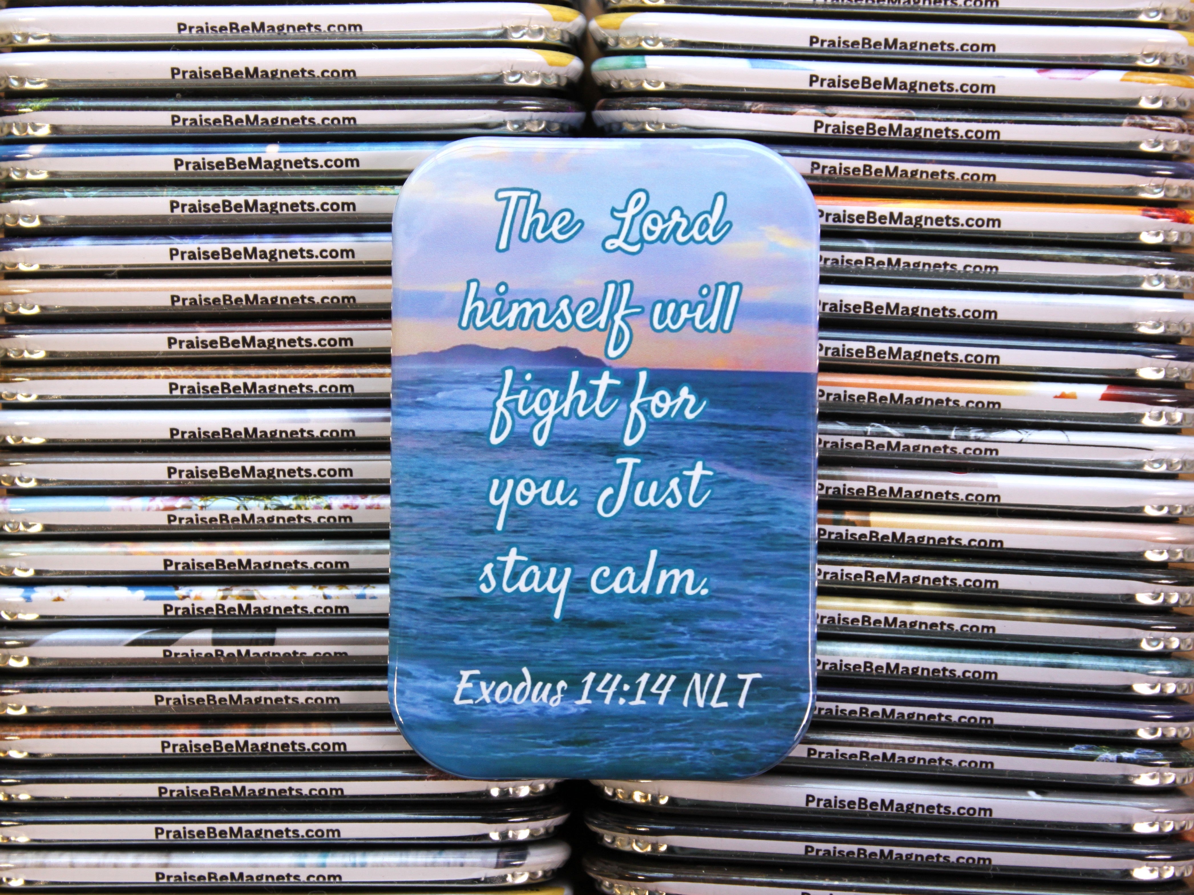 Stack of phone cases with motivational quote and ocean design, branded 'PraiseBeMagnets.com'.