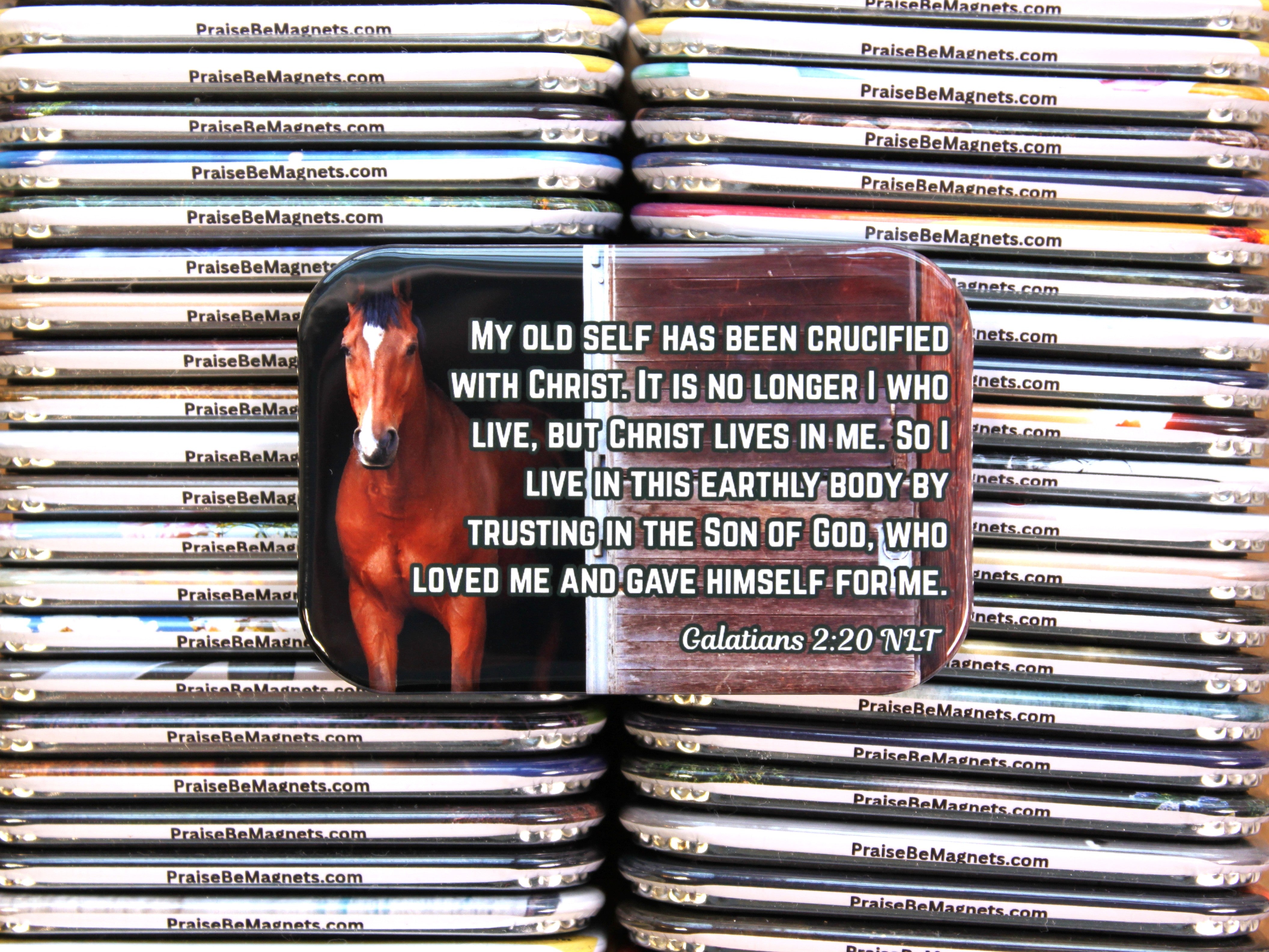 Stack of PrayReMagnets with a magnet featuring a horse and religious text.