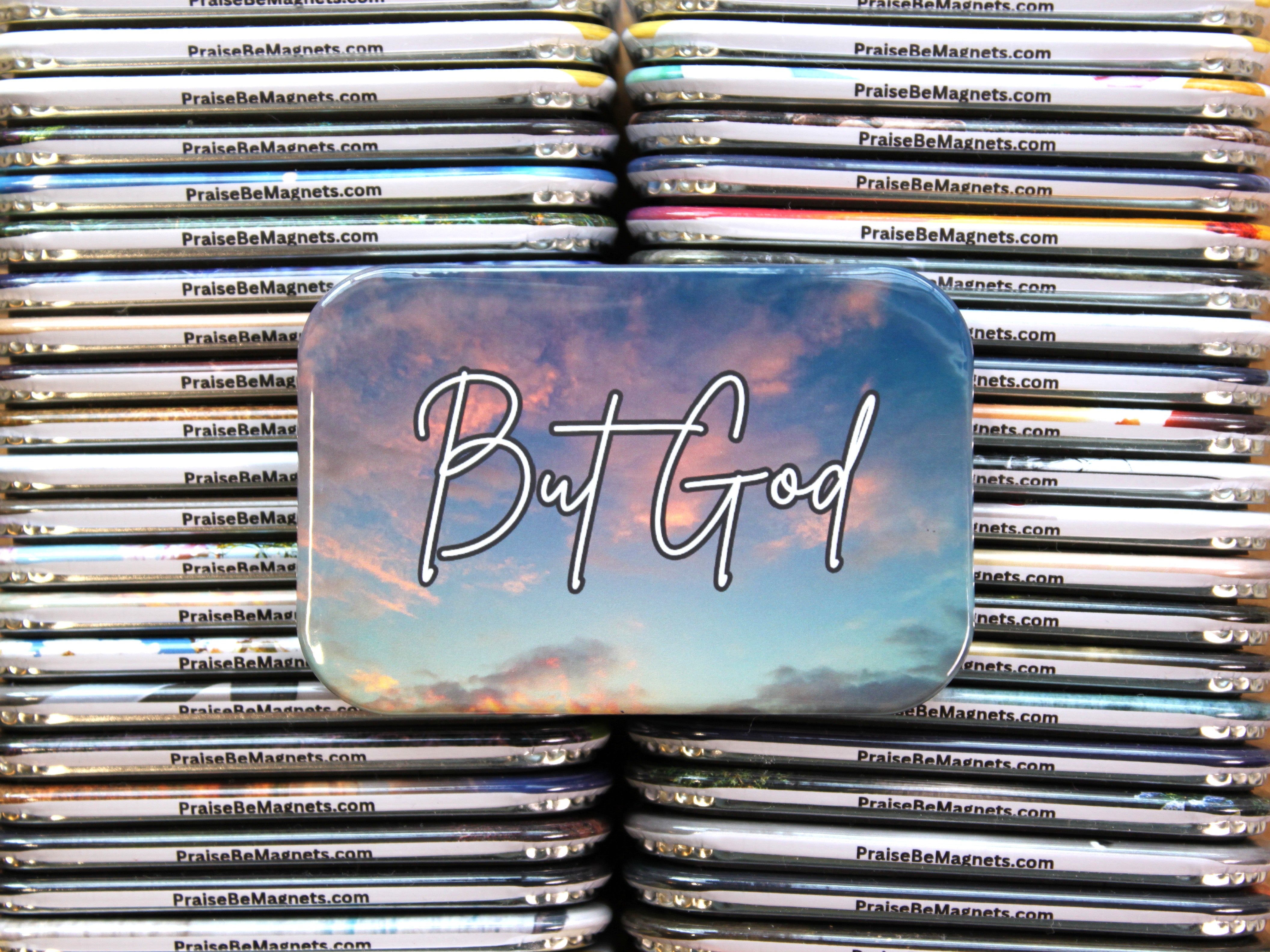 Stack of 'Praise Be Magnets' with a prominent magnet featuring 'But God' text.