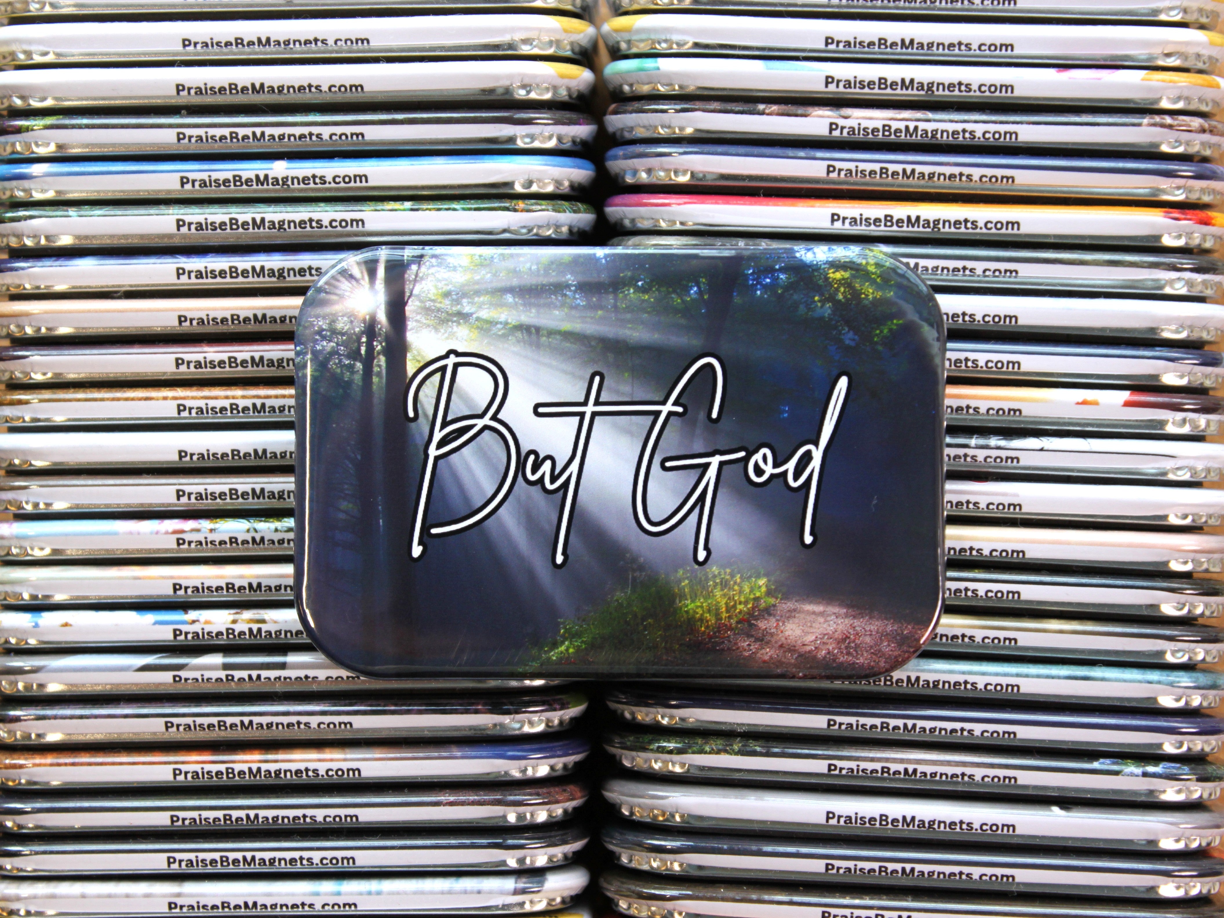 Stack of 'PraiseBeMagnets' with a prominent magnet featuring 'But God' text.