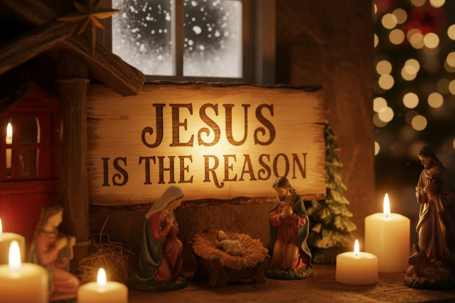 Nativity scene with 'Jesus is the Reason' sign and Christmas decorations.