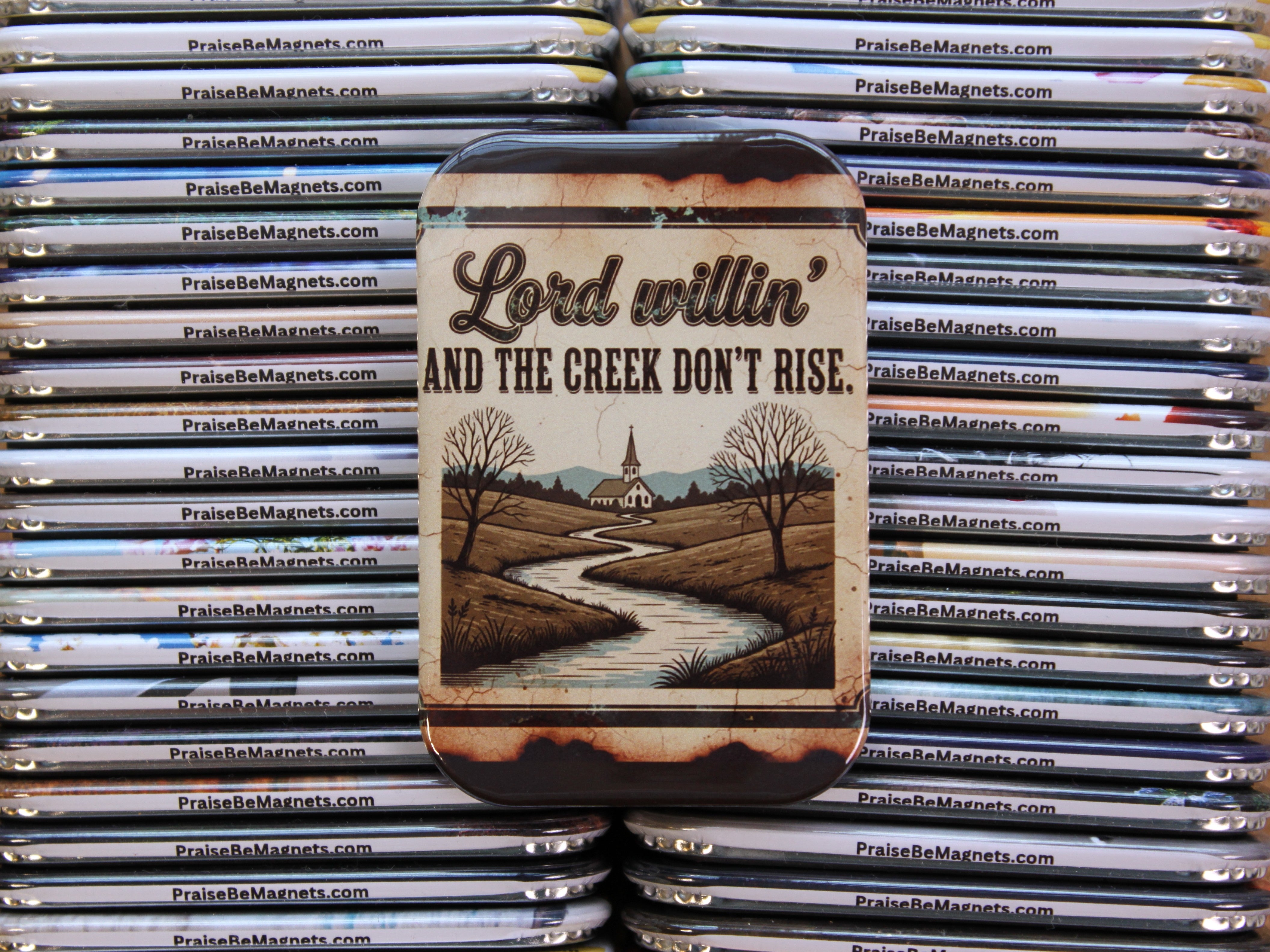 Phone case with 'Lord willin' and the creek don't rise' design on a stack of similar phone cases.