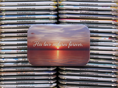 Stack of 'PraiseBeMagnets' with a prominent magnet in the foreground displaying 'His love endures forever.'