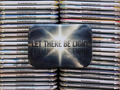 Stack of metal magnets with 'PraiseBeMagnets.com' branding, featuring a prominent magnet with 'LET THERE BE LIGHT' text.