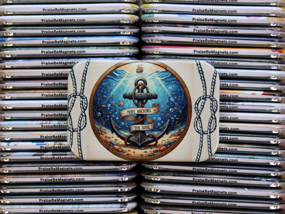 Stack of 'Praise Be Magnets' with a decorative magnet featuring an anchor design.