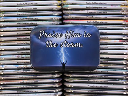 Stack of 'Praise Him in the Storm' magnets with a blue background
