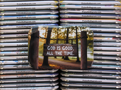 Stack of 'PraiseBeMagnets' with a magnet featuring 'God is Good, All the Time.' text.