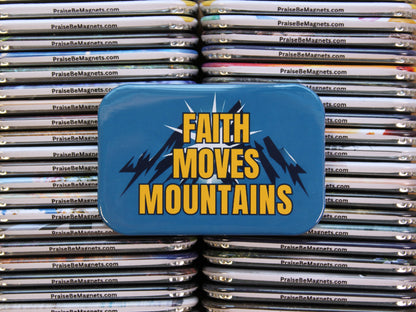Blue tin with 'Faith Moves Mountains' text on a stack of metal magnets.