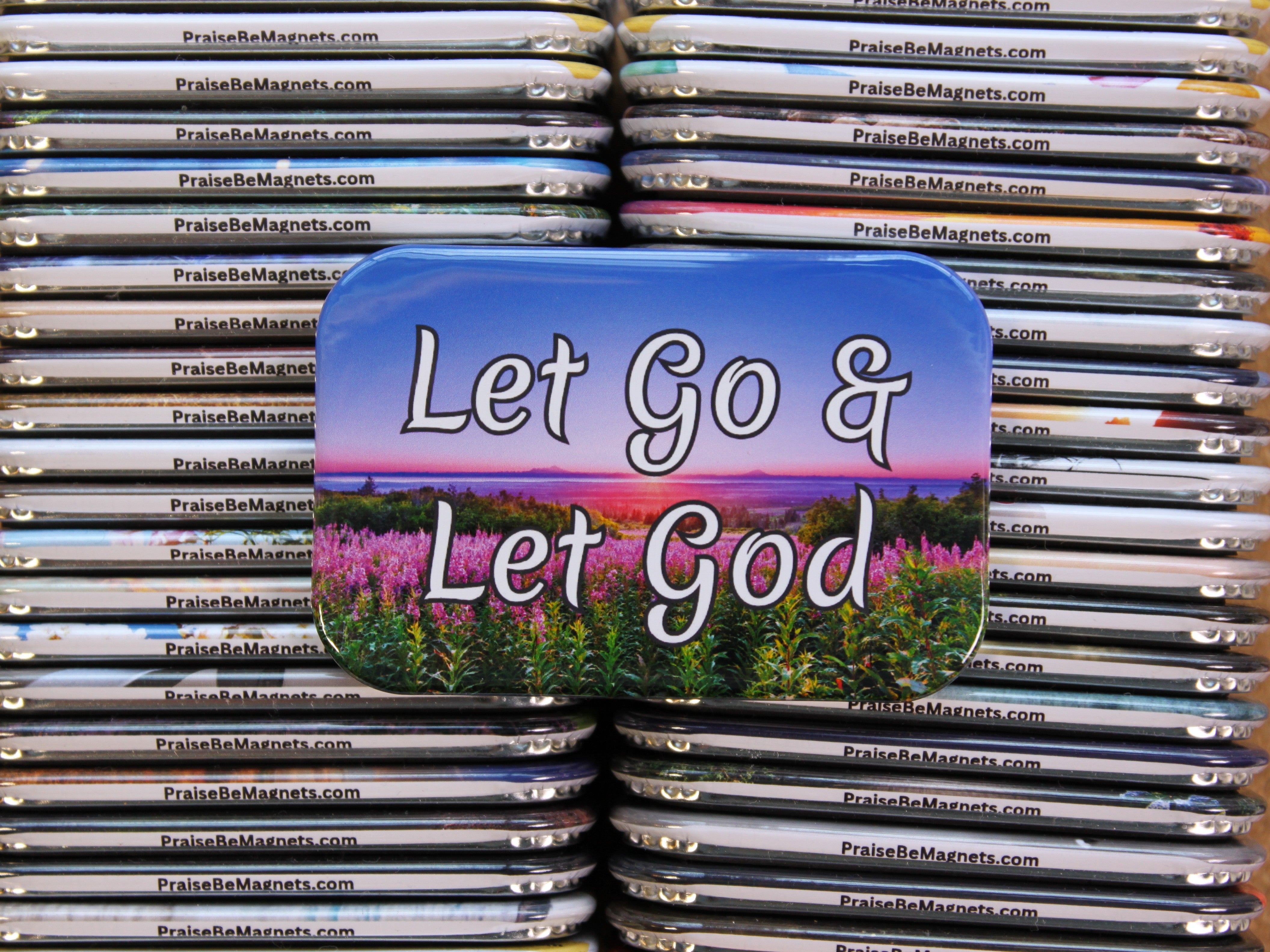 Stack of magnets with 'Let Go & Let God' text and nature design.