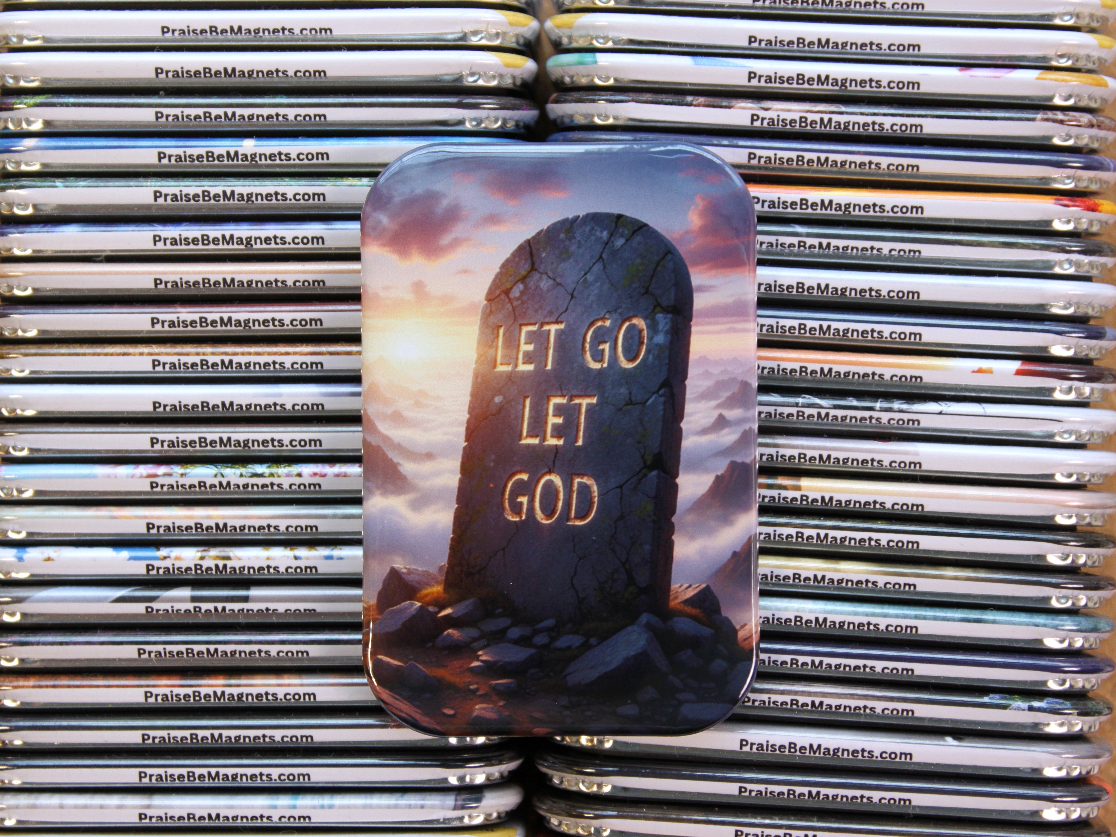 Magnet with 'Let Go Let God' text on a stack of similar magnets