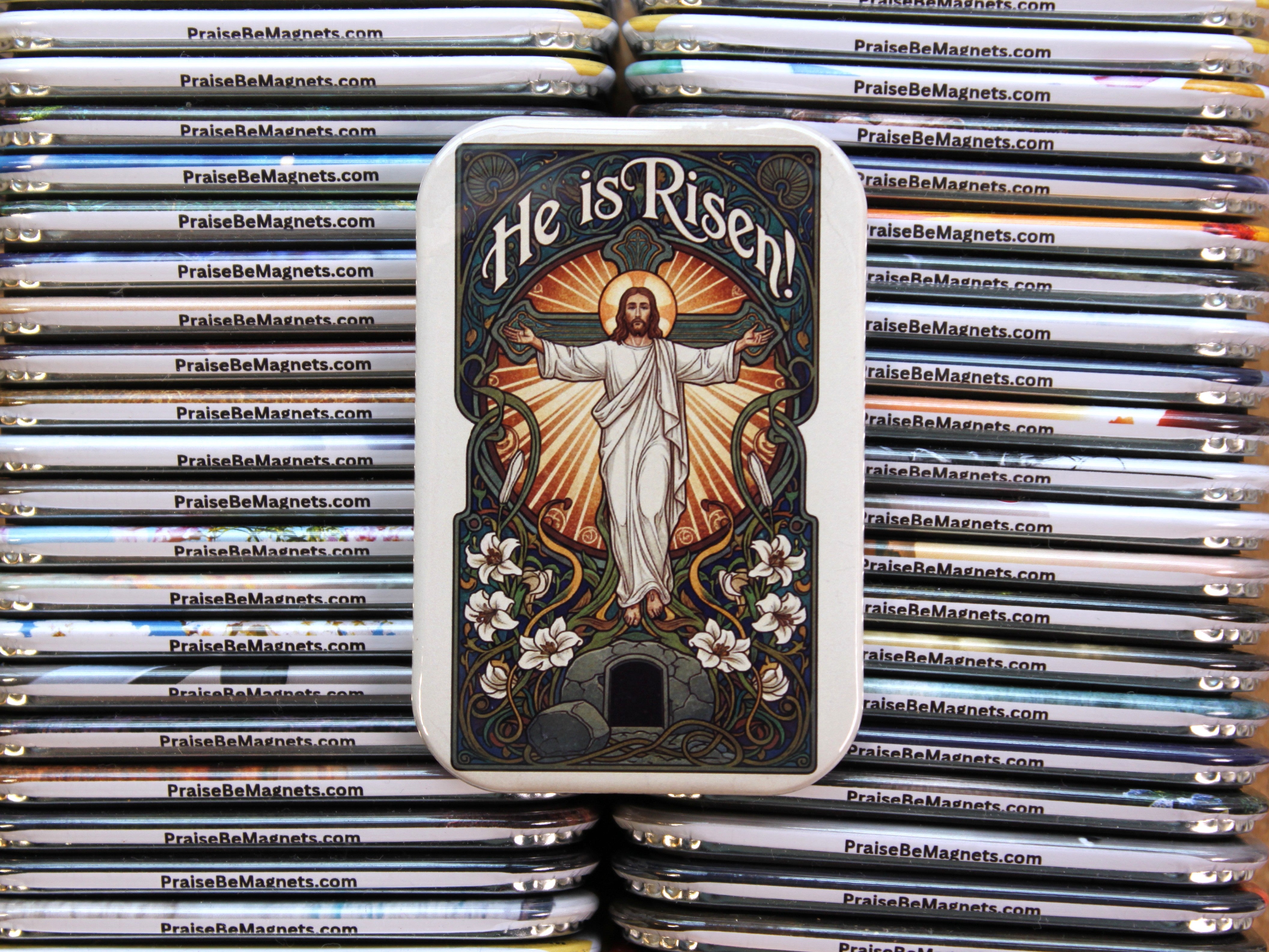 Stack of 'He is Risen!' magnets with a religious design.