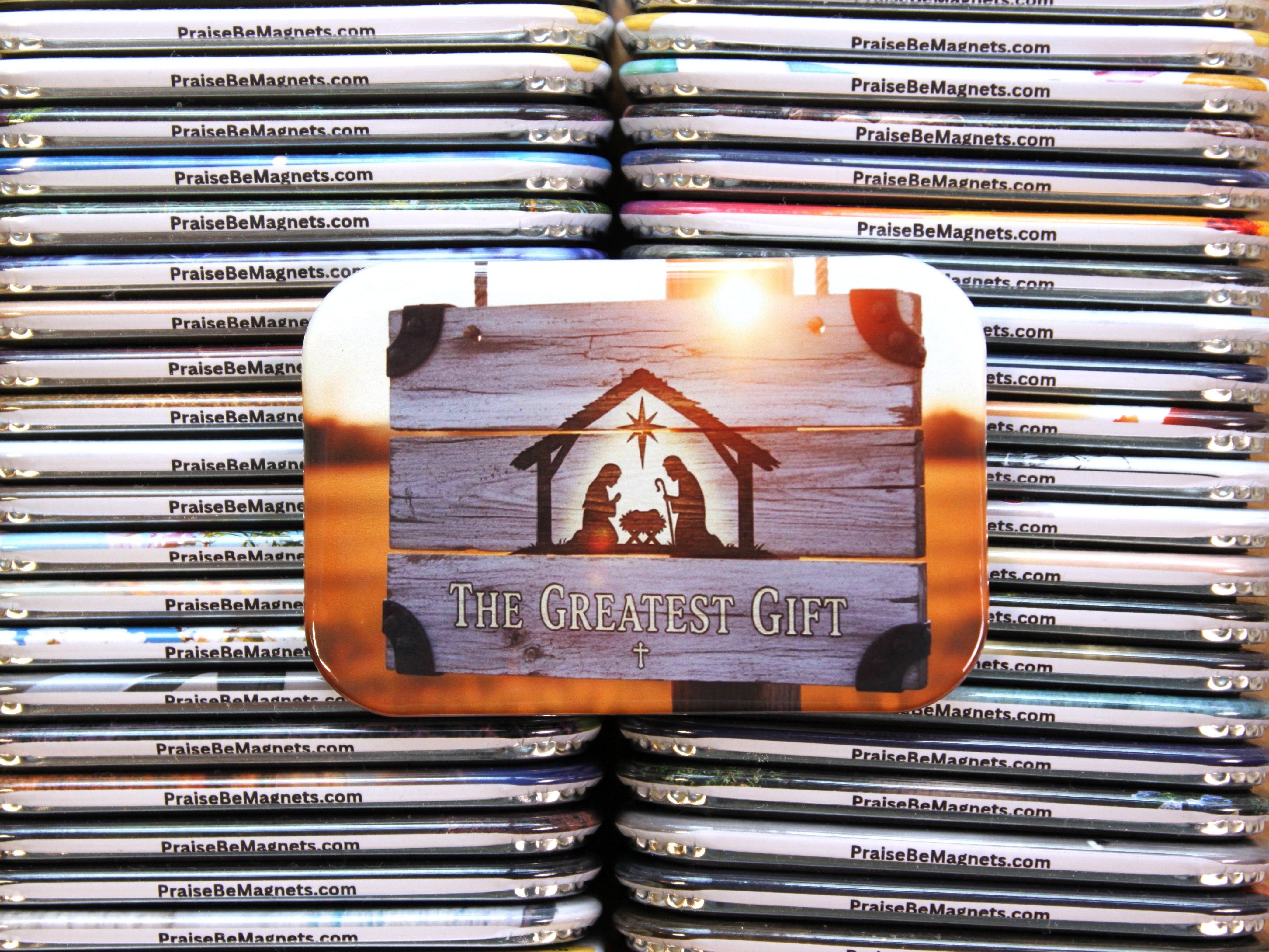 Stack of 'PraiseBeMagnets' with a nativity scene magnet on top