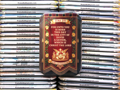 Decorative magnet with religious text and imagery on a stack of similar magnets.