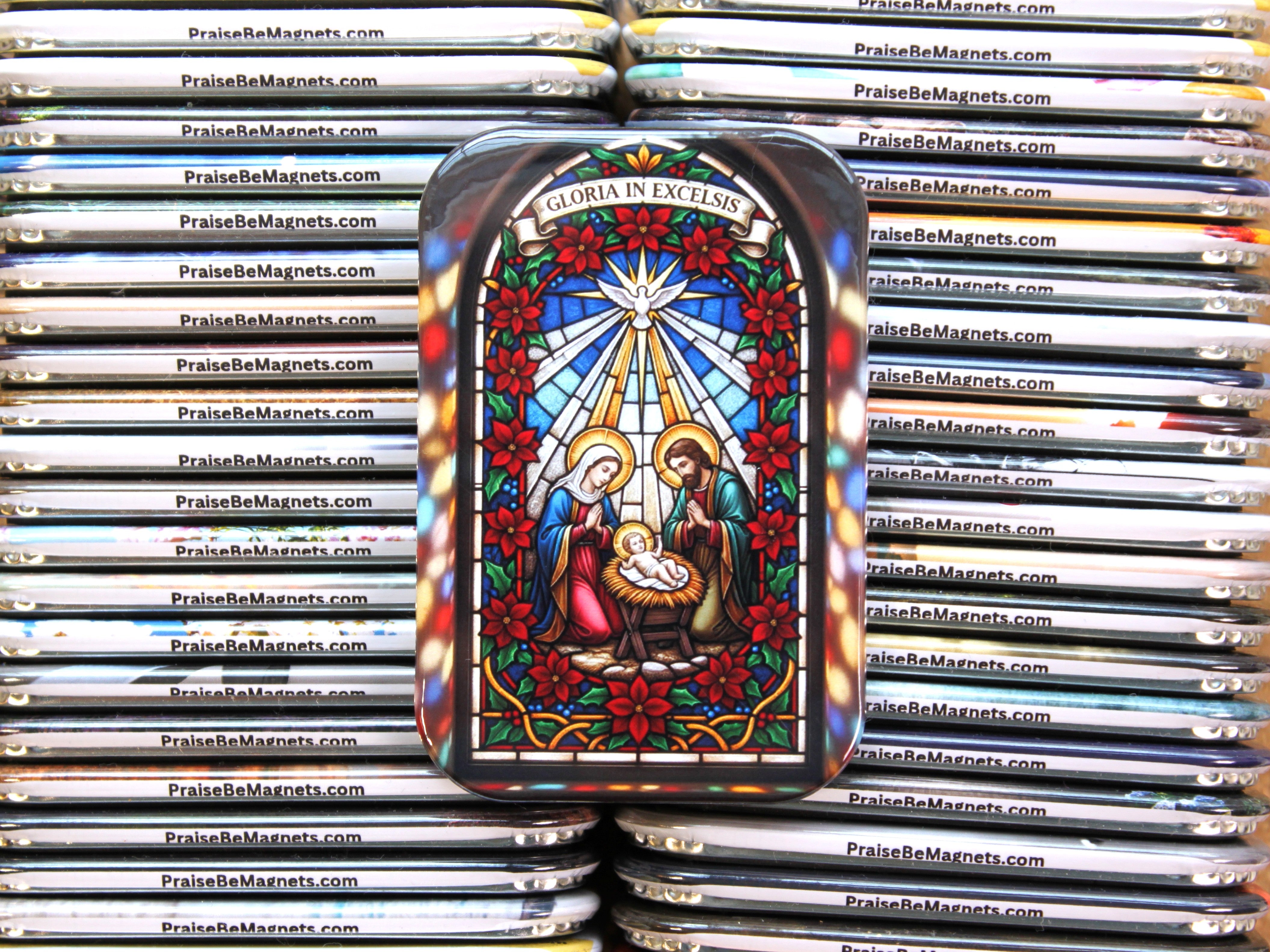 Decorative magnet with nativity scene design on a stack of similar magnets.