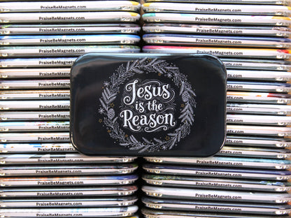 Stack of metal magnets with 'Jesus is the Reason' text on a black tin lid.