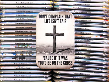 PraiseBeMagnets with a cross and motivational quote on a stack of similar magnets.