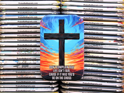 Stack of PrayseBeMagnets with a cross design and motivational quote.