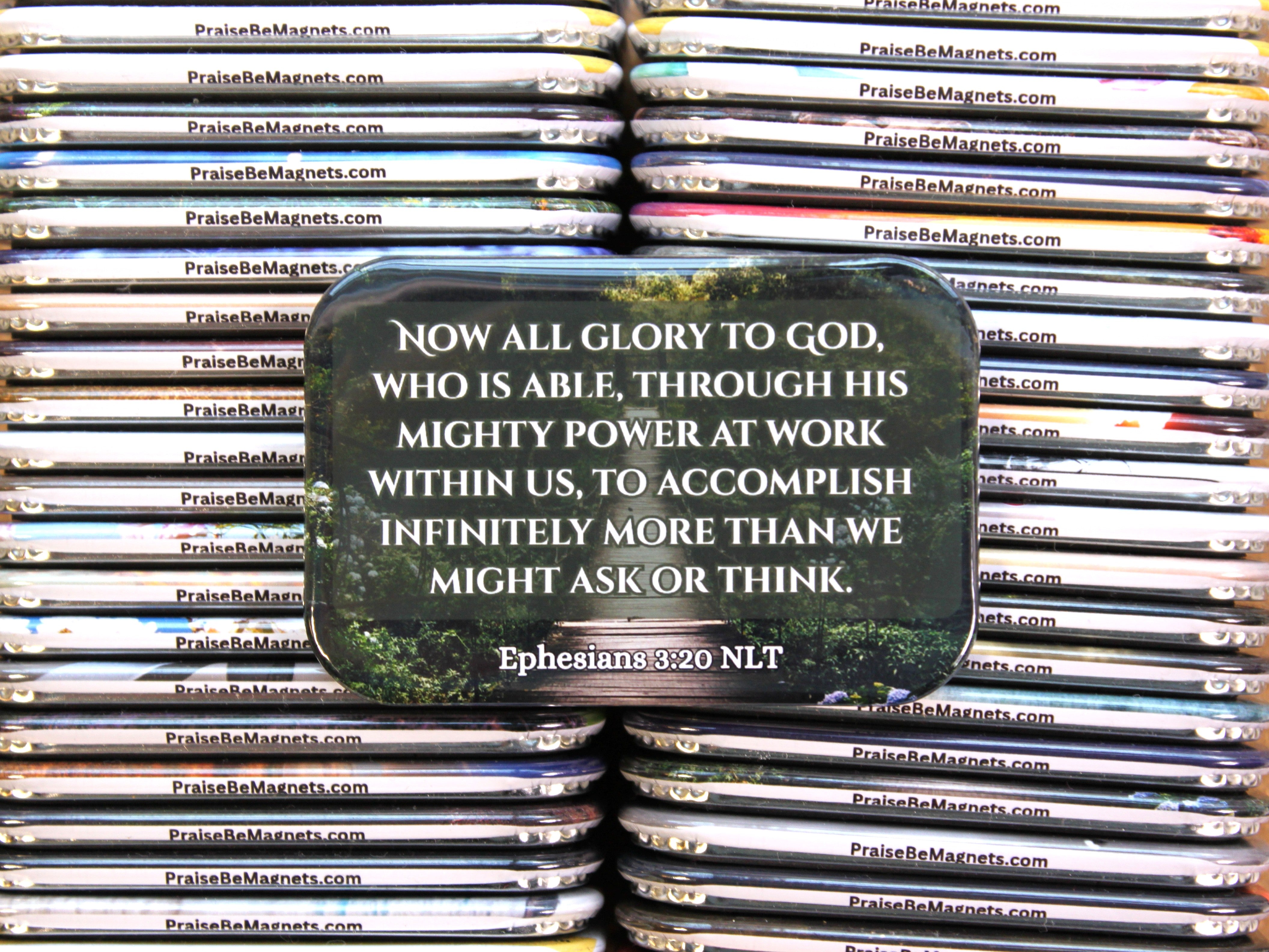 Stack of 'Praise Be' magnets with a central magnet featuring a quote.