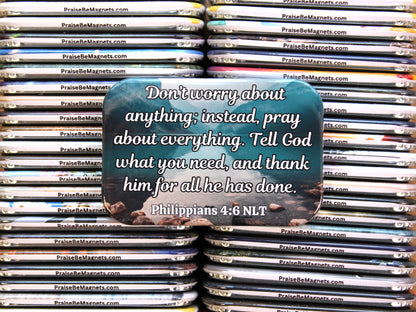 Stack of 'Praise Be' magnets with a central magnet featuringPhilippians 4:6 NLT text.