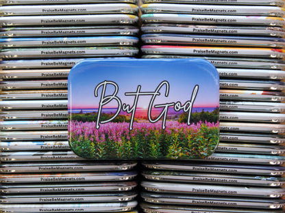 Stack of magnets with a colorful design featuring 'But God' and a landscape.